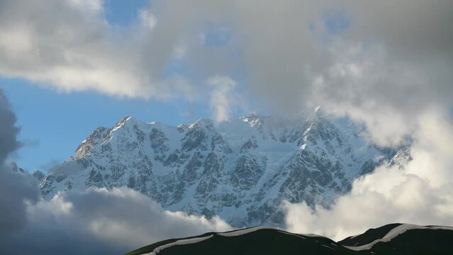 Beautiful time-lapse in the mountains. Snow covered mountains and clouds timelapse.