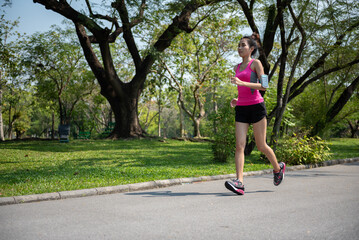 Young Asian healthy woman running in the park.