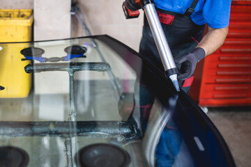 Replacement of car glass in a car service.