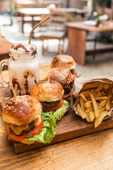 Burgers, fries and a cream and nuts milkshake