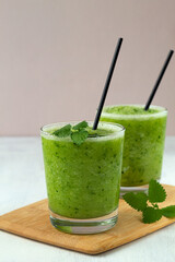 green smoothie.Green healthy smoothie with organic ingredients, with green vegetables on the light background. Raw, vegan, vegetarian, detox food and drink. copy space