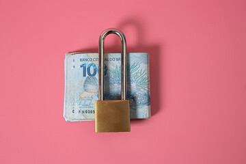 A padlock with a wad of money