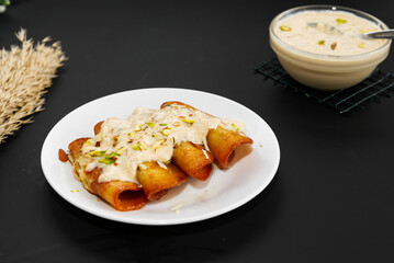 Malpua is a popular Indian sweet of fried fluffy pancakes dipped in sugar syrup and served with rabdi 