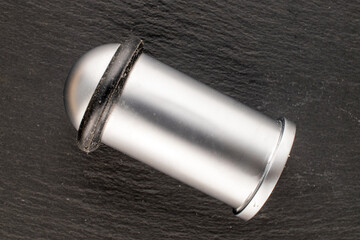 One metal door stop, close-up, isolated on a white background.