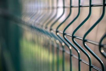 Fence made of steel bars. Fence made of netting in parking lot. Steel mesh. Obstacle from...