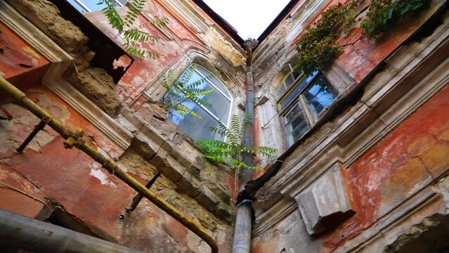 Very old ancient ruined building in the inner yard in street of Odessa, Ukraine. High quality FullHD footage