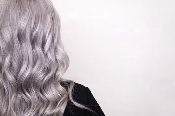 Female back with long curly silver hair with copy space