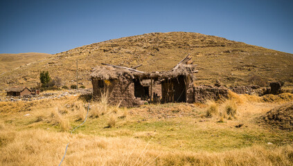 abandoned house near mountains and yellow landscape in yanaoca, cusco, peru