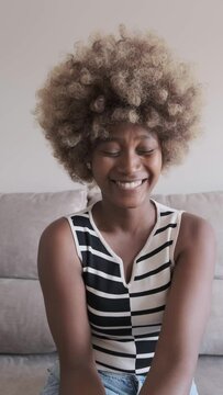 Happy black woman laughing at joke