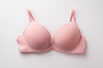 Breast cancer awareness concept. Top view photo of pink brassiere on isolated white background - obrazy, fototapety, plakaty
