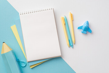 School supplies concept. Top view photo of yellow and blue school accessories notebooks plane shaped sharpener pens and pencil-case on bicolor blue and white background with copyspace