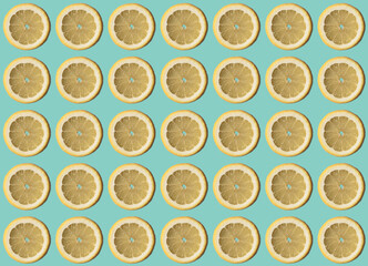 Yellow lemon slices pattern on light blue pastel color in vintage look.