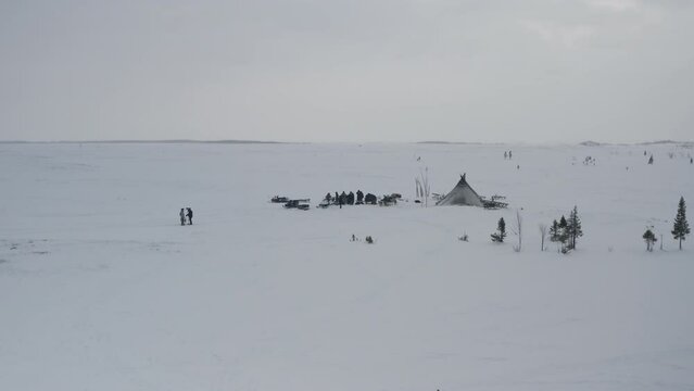 A camp of yurts of a small northern people in the Arctic. Aerial view of the winter landscape of the yurt camp with reindeer