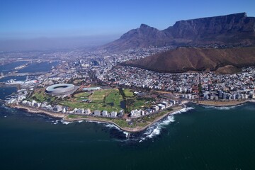 Fototapeta premium aerial view over Cape Town with sea point coastline and stadium in foreground and city, harbour and table mountain in background