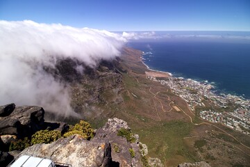 white cloud over Cape Town Table Mountain and view to coast and blue sea