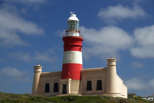 front view of Cape Agulhas Lighthouse in red and white, blue sky