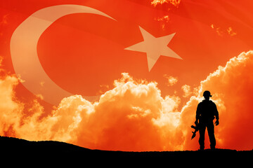 Silhouette of soldier on a background of Turkey flag and the sunset or the sunrise. Concept of...