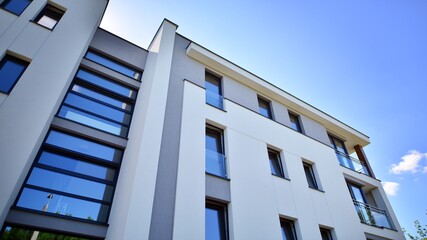 Modern luxury residential flat. Modern apartment building on a sunny day. Apartment building with a blue sky. Facade of a modern apartment building. - obrazy, fototapety, plakaty