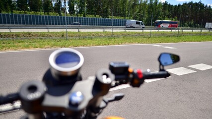 Blurred handlebars and speedometer of motorbike