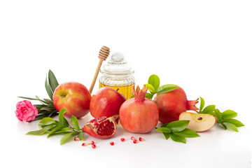 Pomegranates, apples and honey on white background, traditional food of Jewish New Year - Rosh Hashanah.