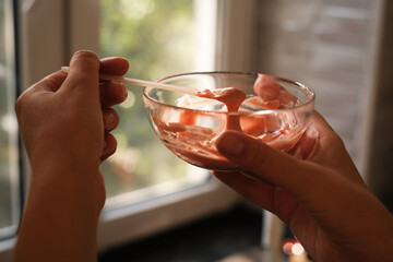 woman making alginate mask at home