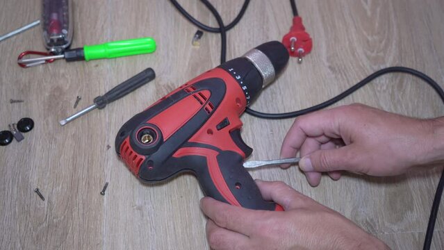 disassemble a broken electric screwdriver,warranty repair of equipment in the service center, inspection and disassembly of the drill