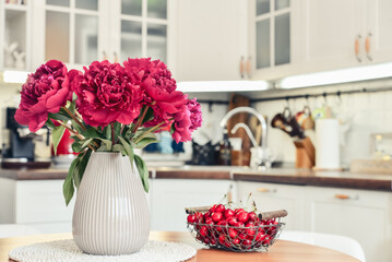 Bouquet of purple peony flowers in interior of the kitchen