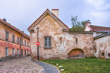 Historic Building In Stone And Bricks With Old Windows