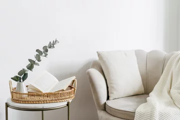 Fotobehang Boho Open book on tray in room, near beige armchair with pillow  © brizmaker