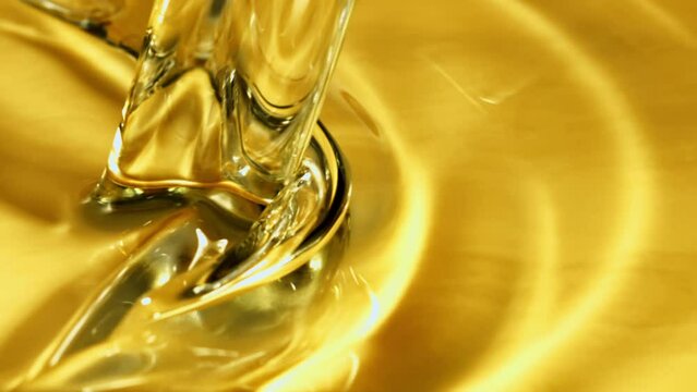 Olive oil pours a whirlpool. Macro background. The texture of olive oil. Filmed is slow motion 1000 fps.