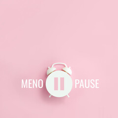 Word Menopause and pause sign on alarm clock on pink background. Minimal creative concept hormone replacement therapy. Сopy space, square orientation