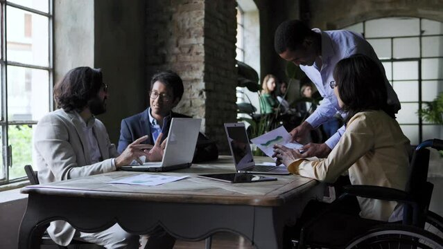Multiracial business group of people working together at conference meeting inside office