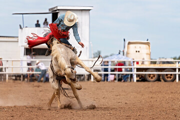 Cowboy On Bucking Bronco At Rodeo