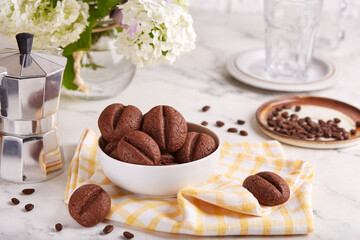 Mocha cookies in a shape of coffee beans. Delicious homemade biscuits with chocolate.