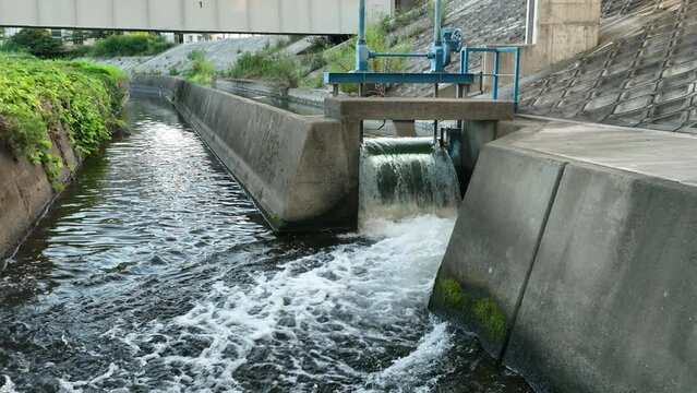Water flows through gate to canal in slow motion