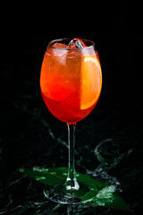 Classic italian aperol spritz cocktail in glass on dark. cocktail aperol