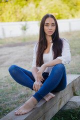 Cute brunette dressed in a shirt and jeans