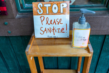 Sign asking customers to use hand sanitizer before entering a store, during the COVID-19 pandemic