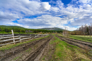 South Ural farm, wooden fence and arable land with a unique landscape, vegetation and diversity of nature.