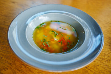 the soup with meat and lentils in a plate. 