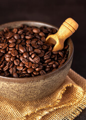 Macro photography of coffee beans, bowl, scoop, burlap