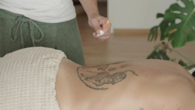 therapist placing a suction cup on a patient's back