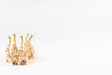 On a white background with space for writing text, a small golden crown.