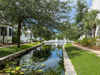 Fototapeta na wymiar A walking path with water feature and homes in Alys Beach, Florida.