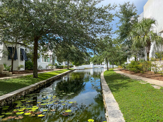 A walking path with water feature and homes in Alys Beach, Florida.