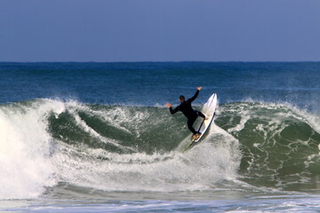 Surfing on high waves in the Mediterranean.