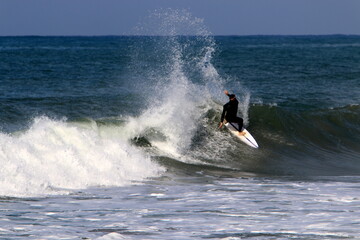 Surfing on high waves in the Mediterranean.