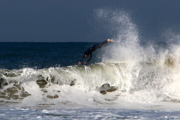 Surfing on high waves in the Mediterranean.
