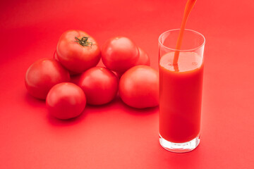 トマトジュースをグラスに注ぐ