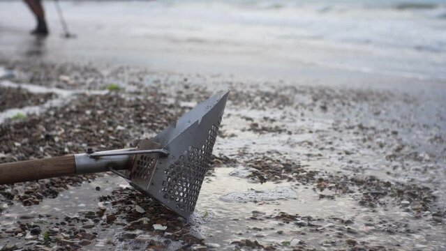 Close view of a scoop on sand. Sand scoops&nbsp;for&nbsp;metal detecting&nbsp;are a must have for any metal detectorist. Sandy beach, seaside, oceanside